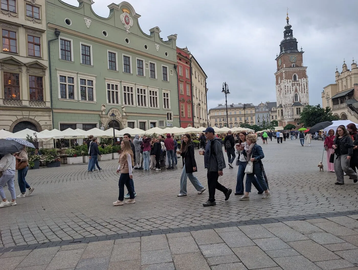 Café terraces and horse carriages on Kraków's Main Market Square