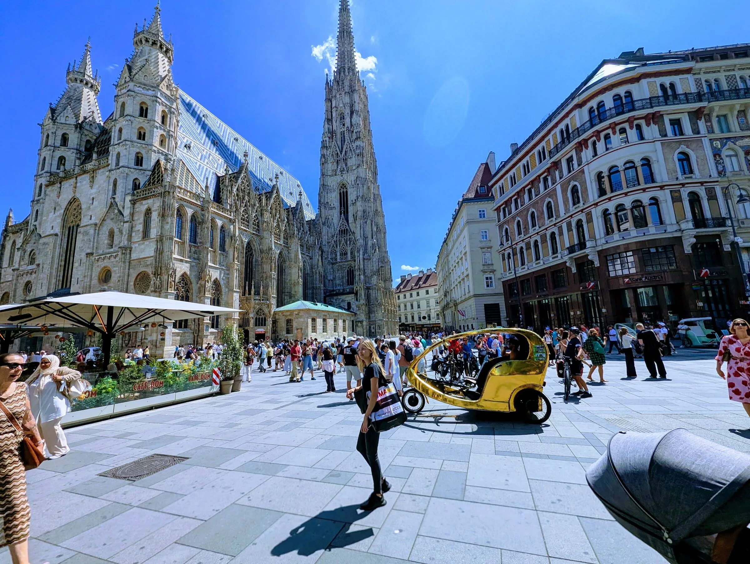 Stephansplatz in Vienna on a sunny afternoon, with St. Stephen's Cathedral and people crossing the square