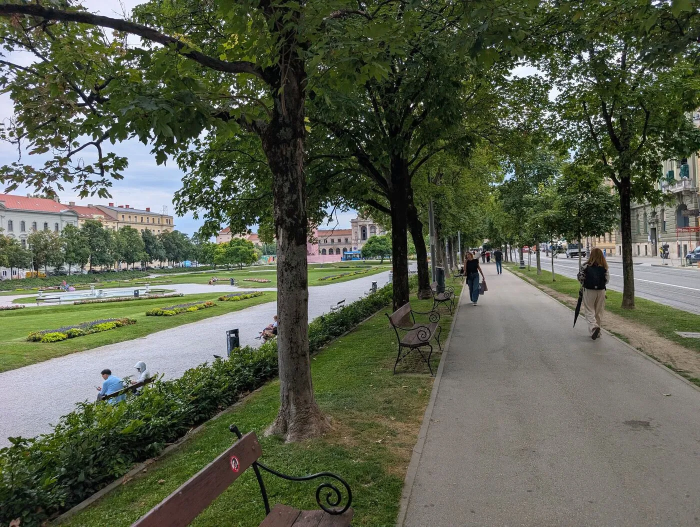 A tree-lined path beside formal gardens in Zagreb